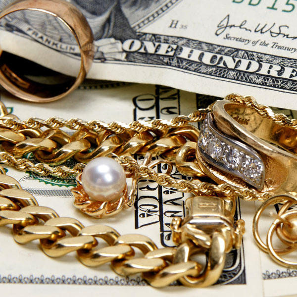 Gold Chains and rings on top of money
