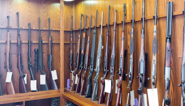 Various Rifles and Shotguns on a display rack